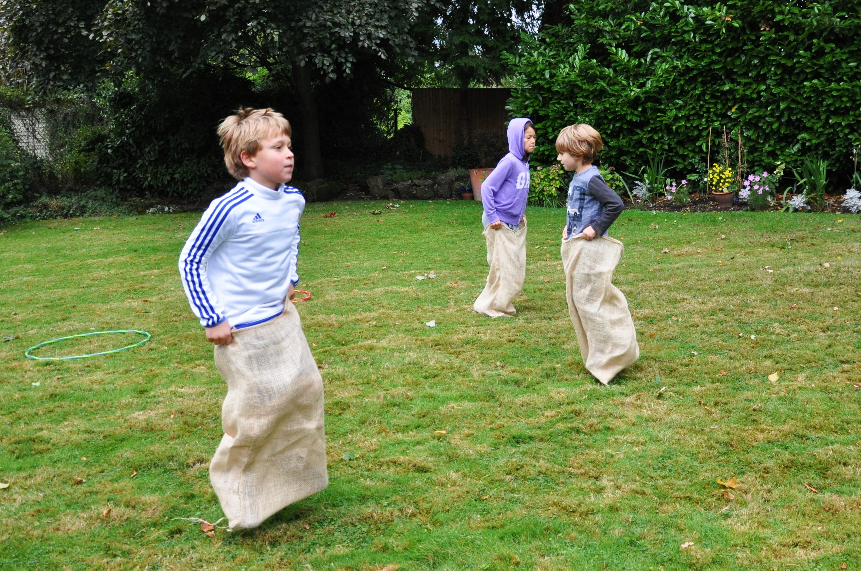 Kids taking part in a sack race at a Kid Fit Parties birthday